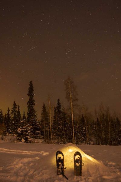 AK A quinzee snow shelter under the night sky